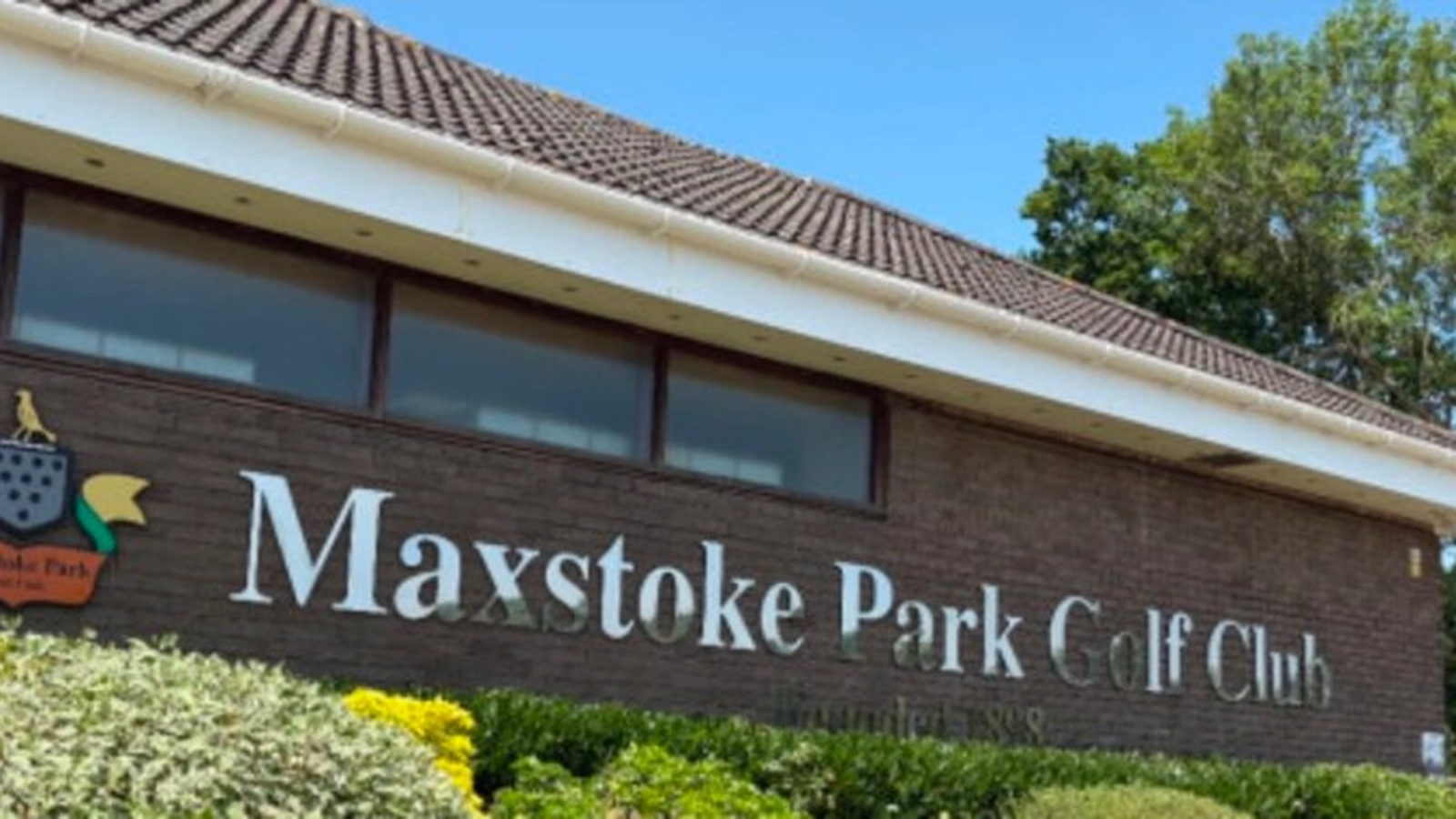 Maxstoke Park Golf Club clubhouse with crest and Founded 1898 sign