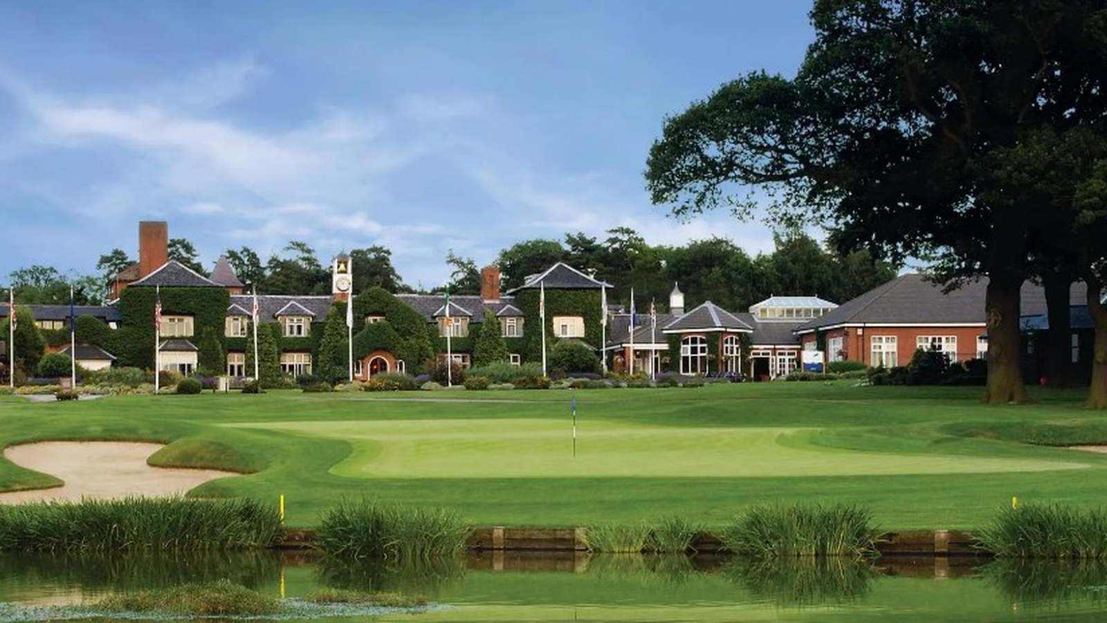 The Belfry golf course with the ivy-covered clubhouse and clock tower beyond the green
