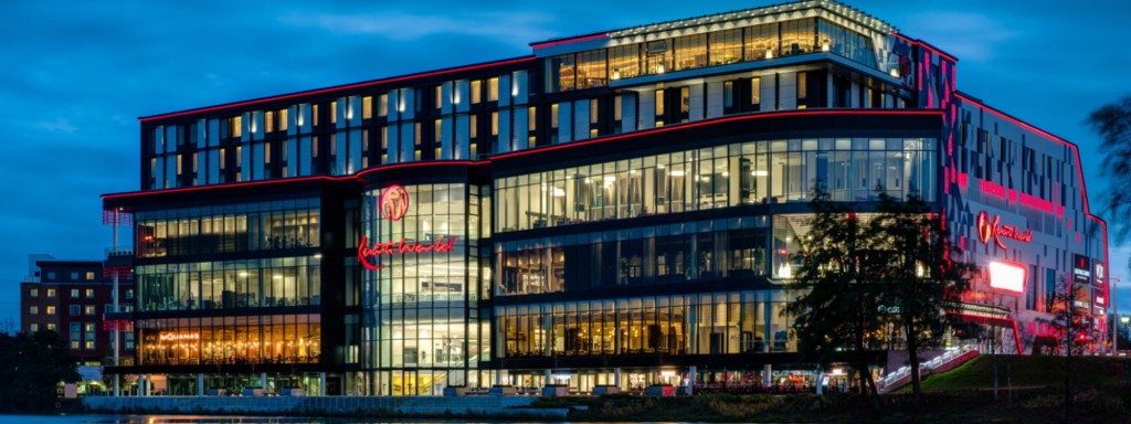 Resorts World Birmingham lit up at night beside Pendigo Lake